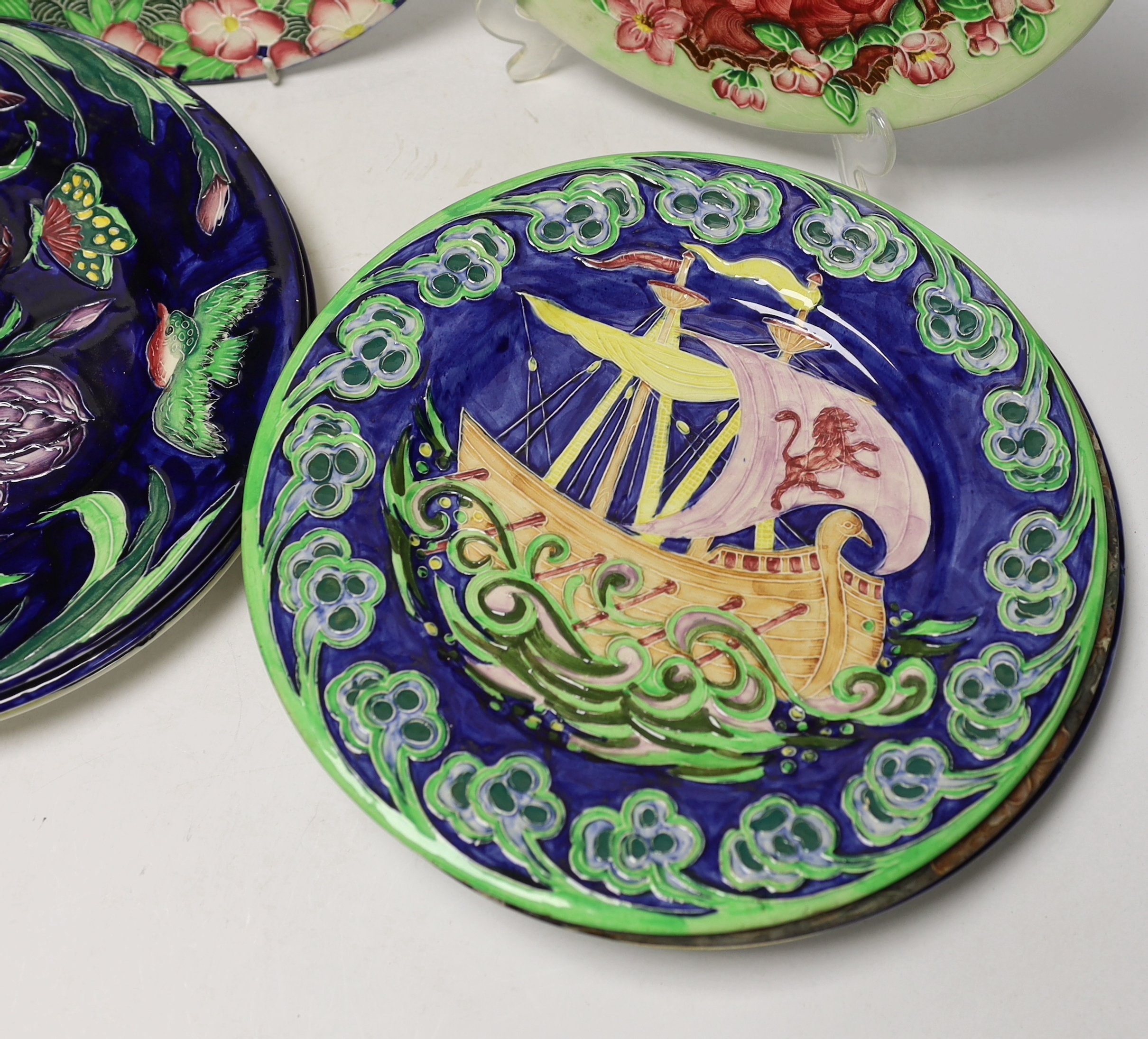 Set of nine Maling, Newcastle pottery plates, many with tube lined decoration including a galleon ship and Windmill, 29cm diameter